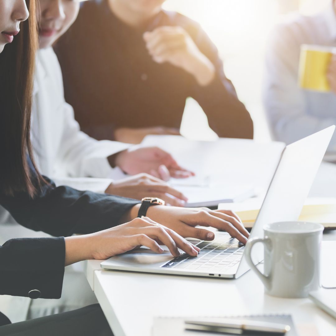 Typing on laptop during meeting