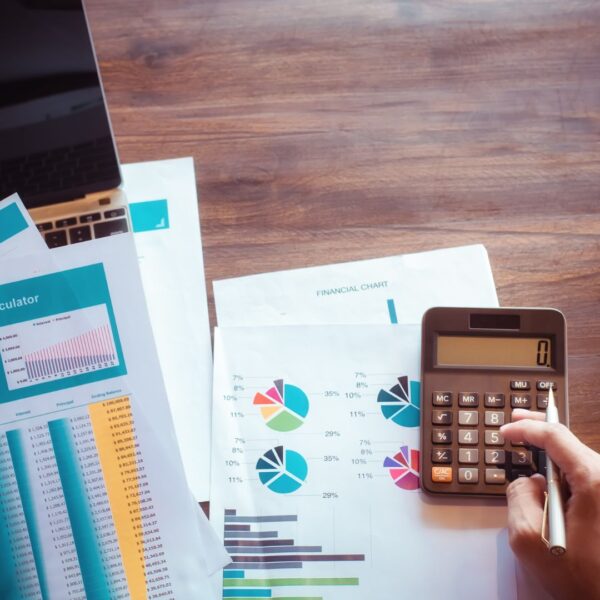 person calculating costs while looking at energy bills